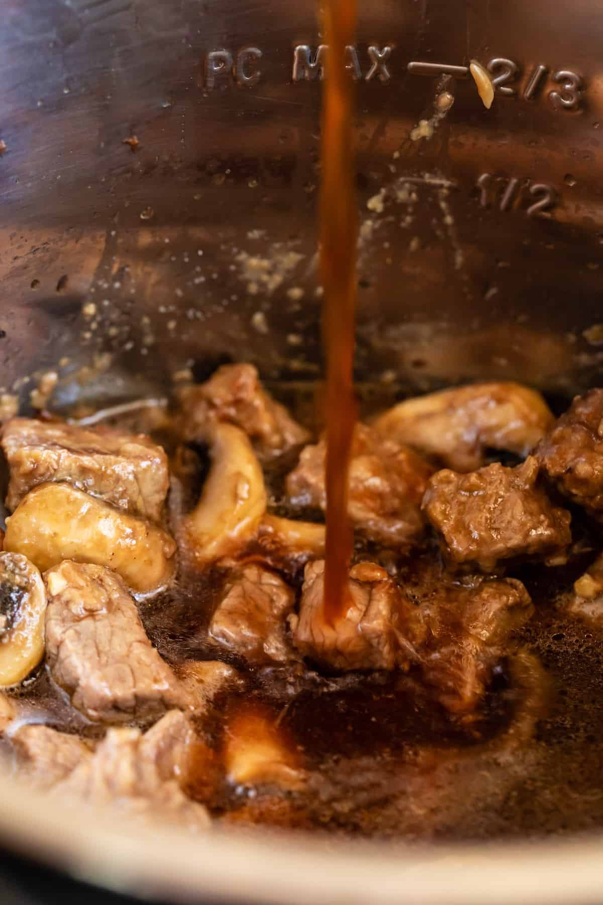 Beef Broth Being Added to the Instant Pot Bowl