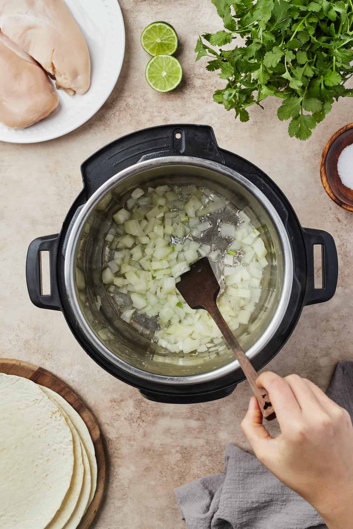 Overhead shot of onions being sauteed in an Instant Pot.