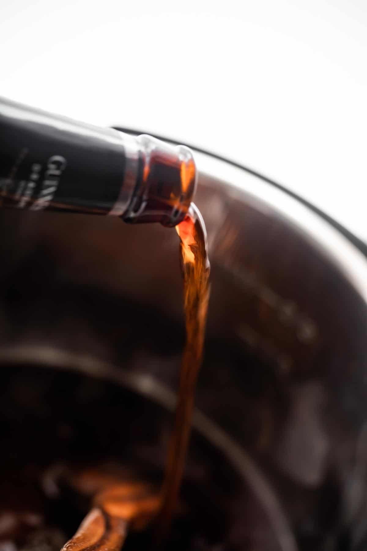 pouring Guinness beer into the insert of an instant pot.