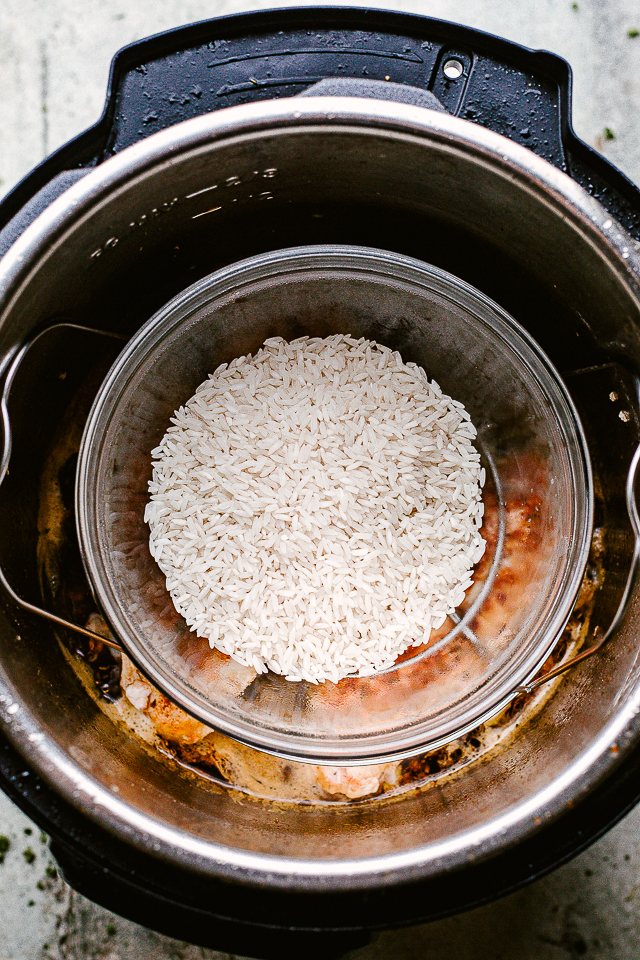 Placing a dish of rice in an Instant Pot to cook.
