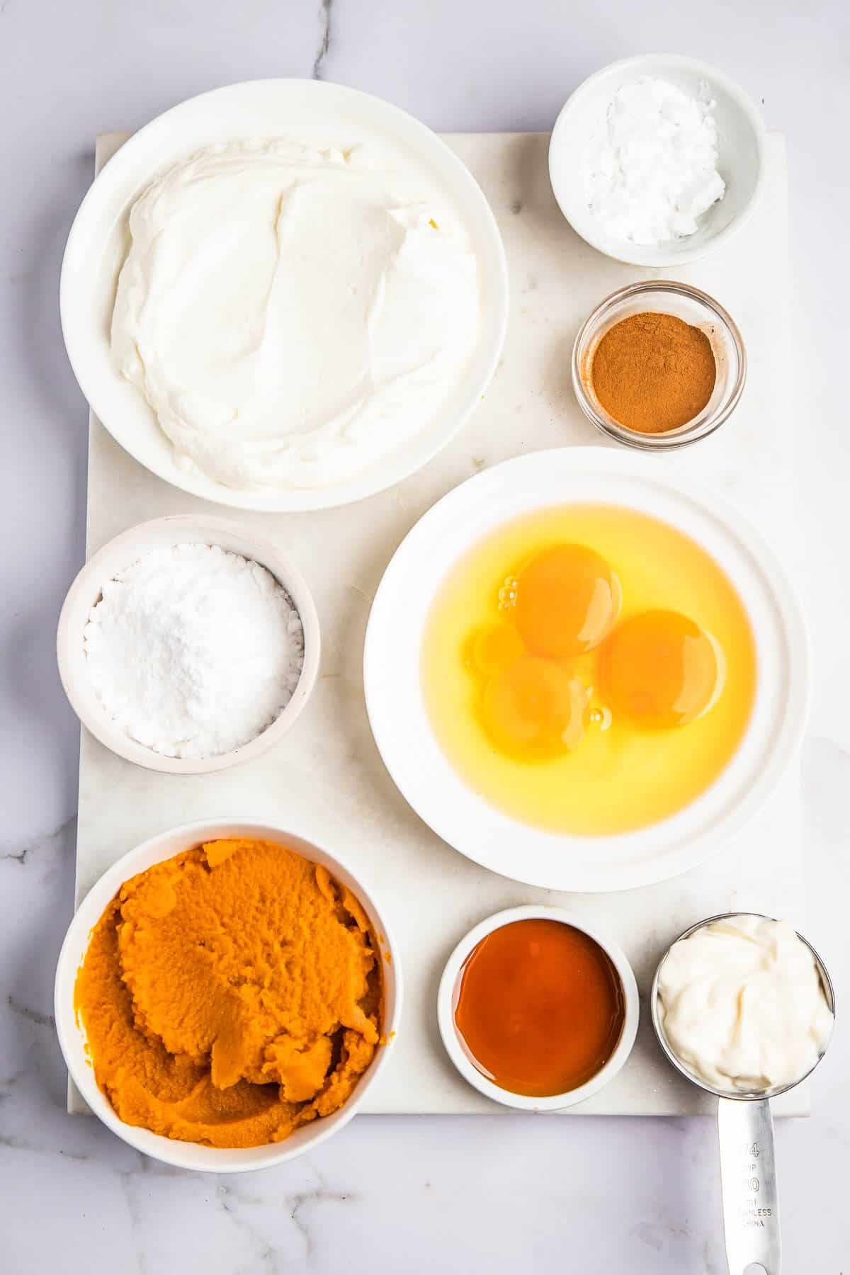 overhead shot of bowls with ingredients for instant pot pumpkin cheesecake