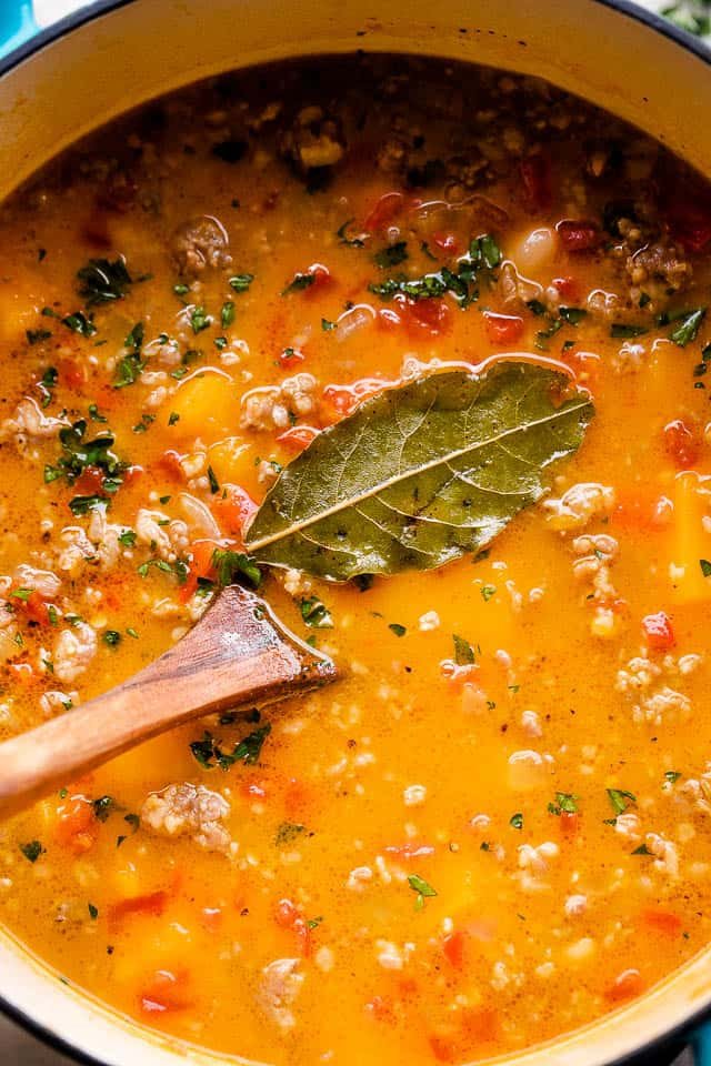 Overhead, close-up image of butternut squash soup cooking in a Dutch oven.
