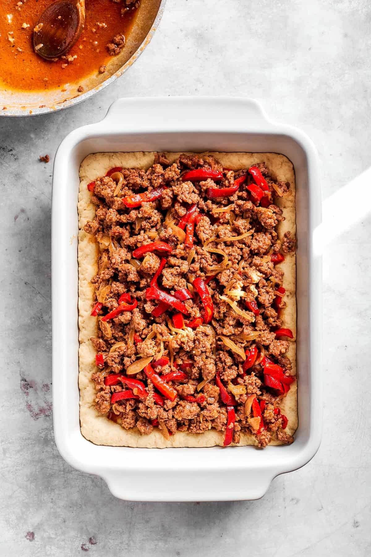 Add cooked beef filling to baking dish.