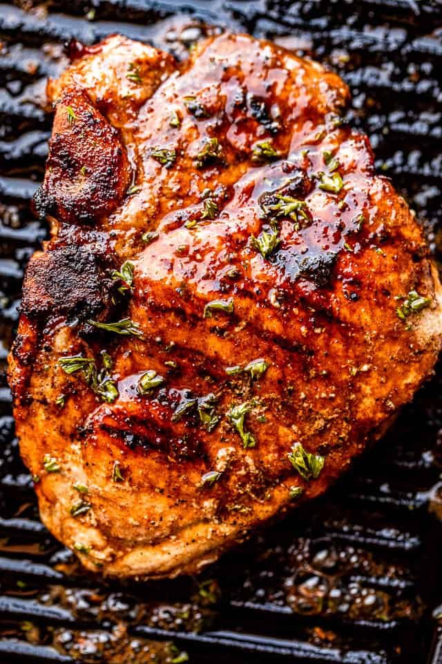 grilled pork chop set against black grill grates