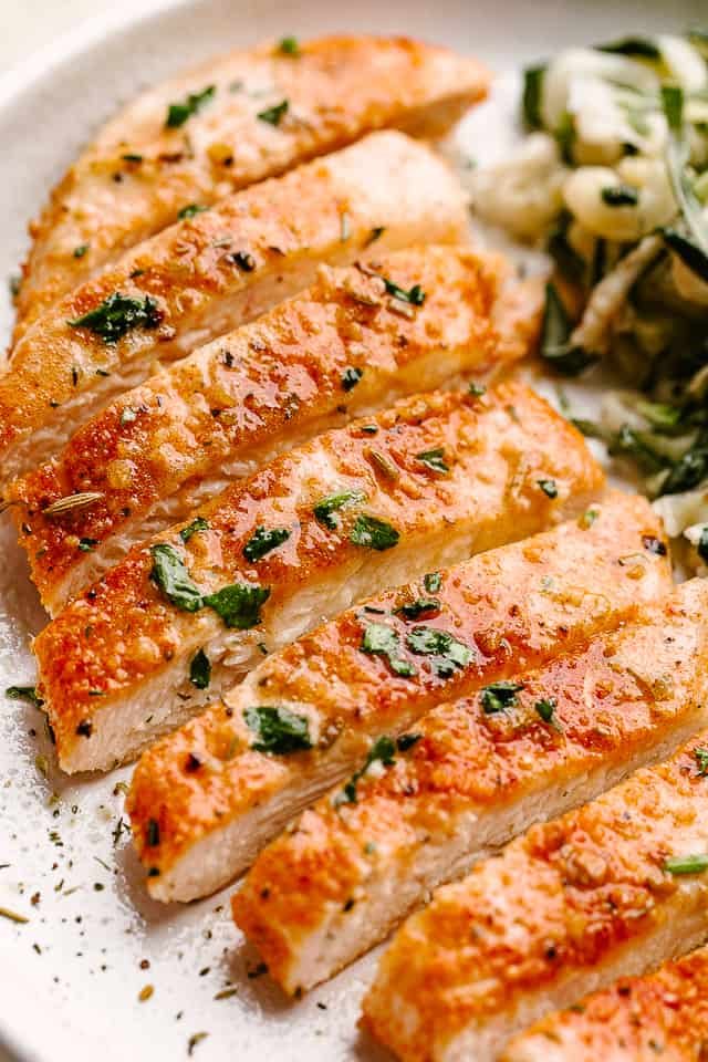Sliced chicken breast on a white plate.