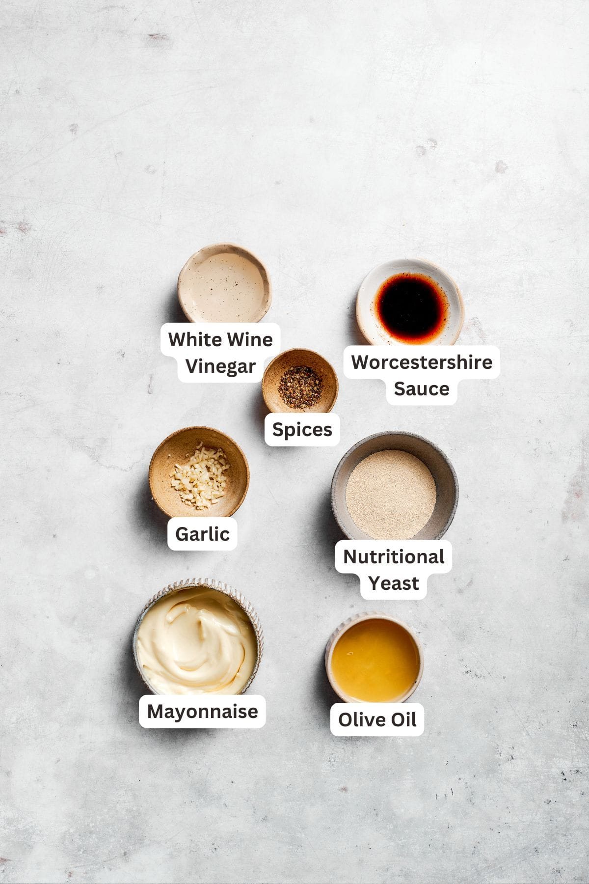 Ingredients for caesar dressing are portioned and labeled.