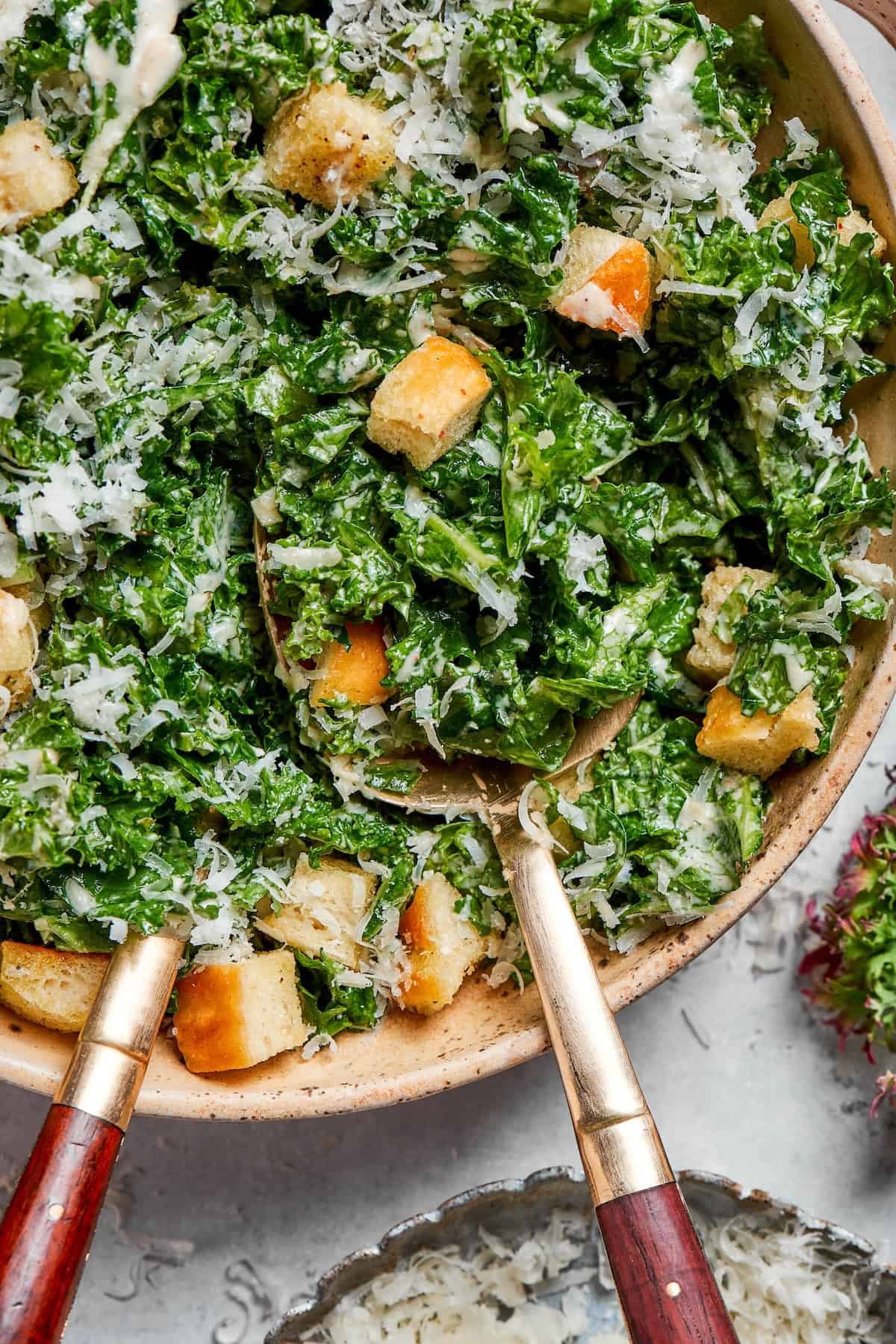 Homemade croutons top a bowl of kale salad.