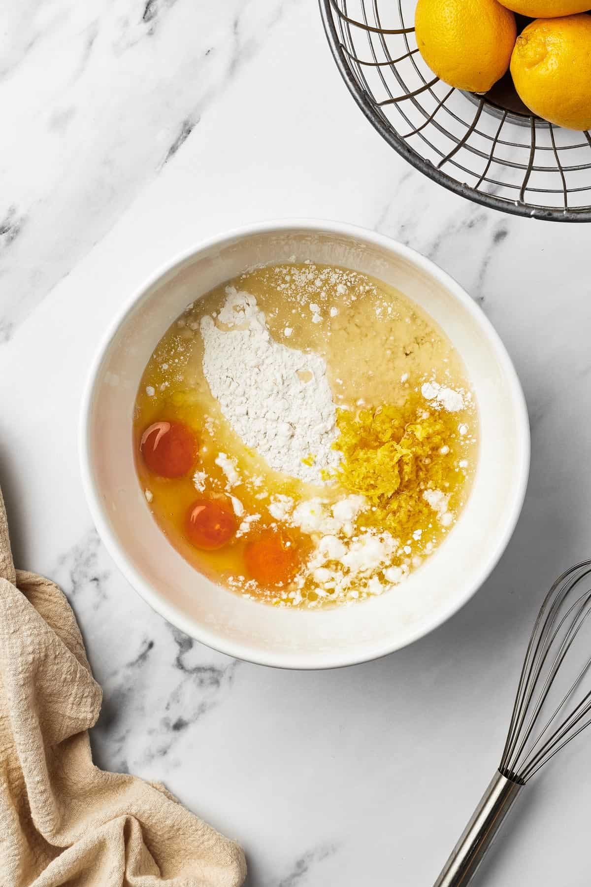 A mixing bowl with cake mix, raw eggs, and other ingredients inside.