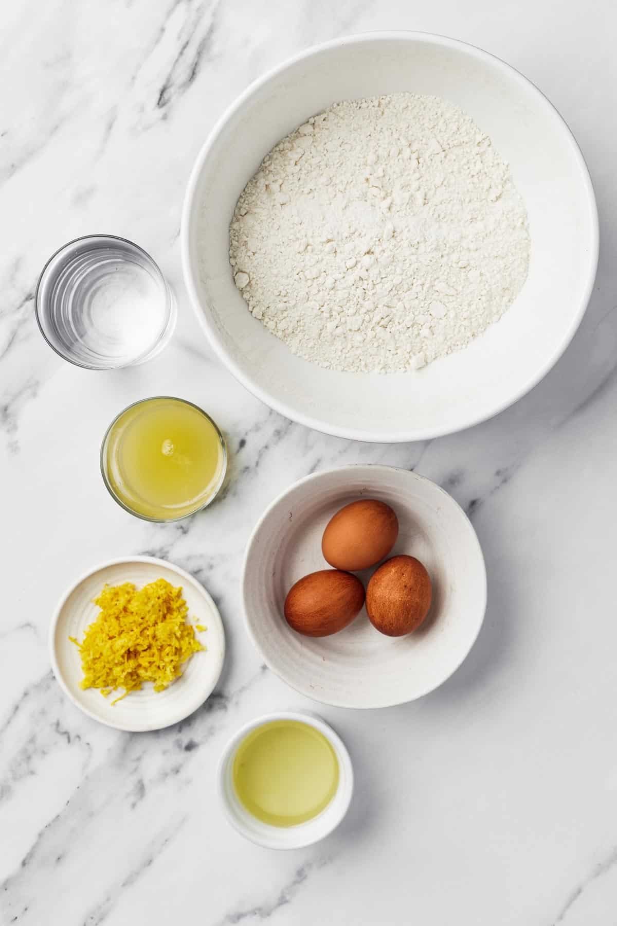 From top left: Water, cake mix, oil, eggs, lemon zest, and lemon juice.