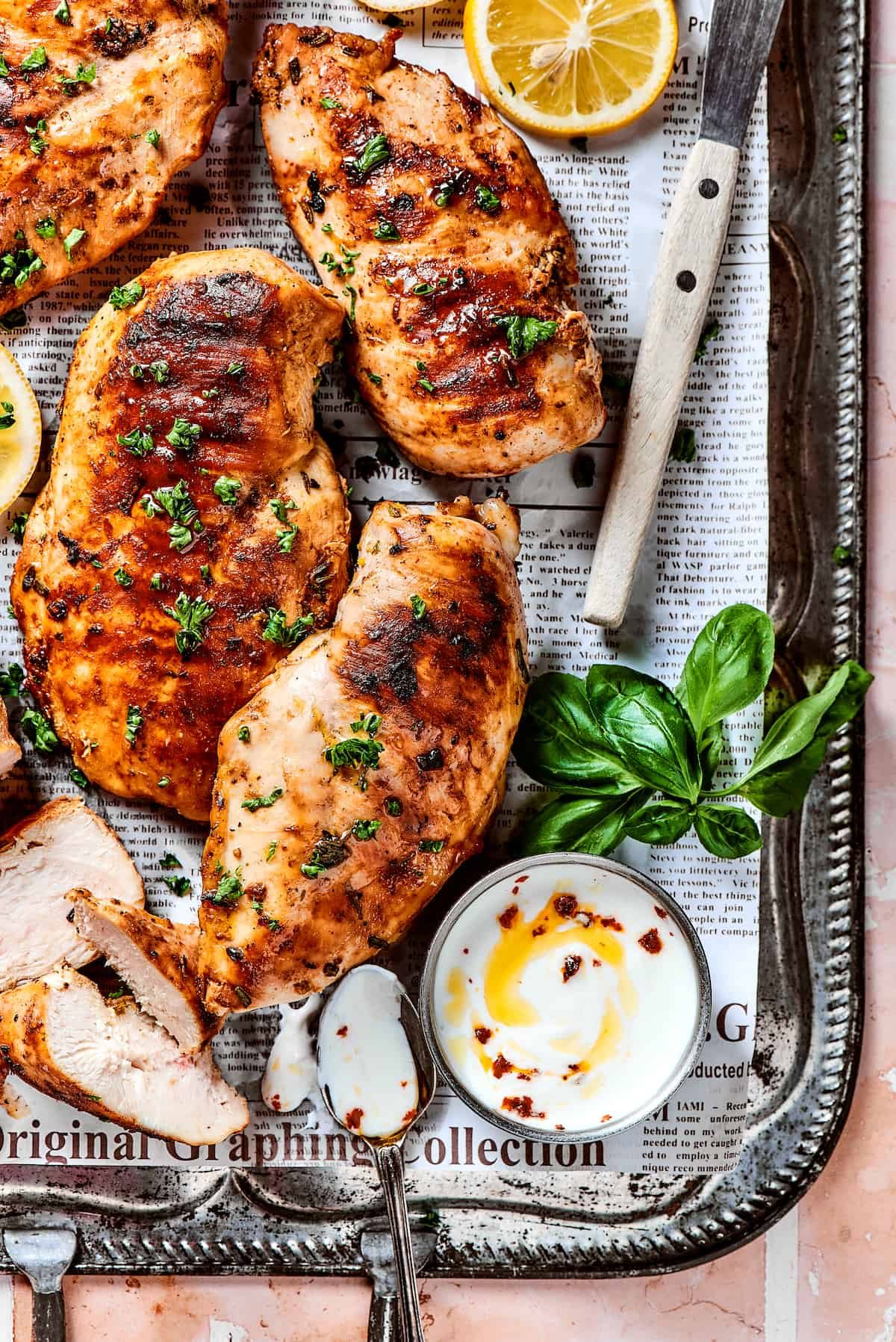 A metal tray of cooked, marinated chicken.