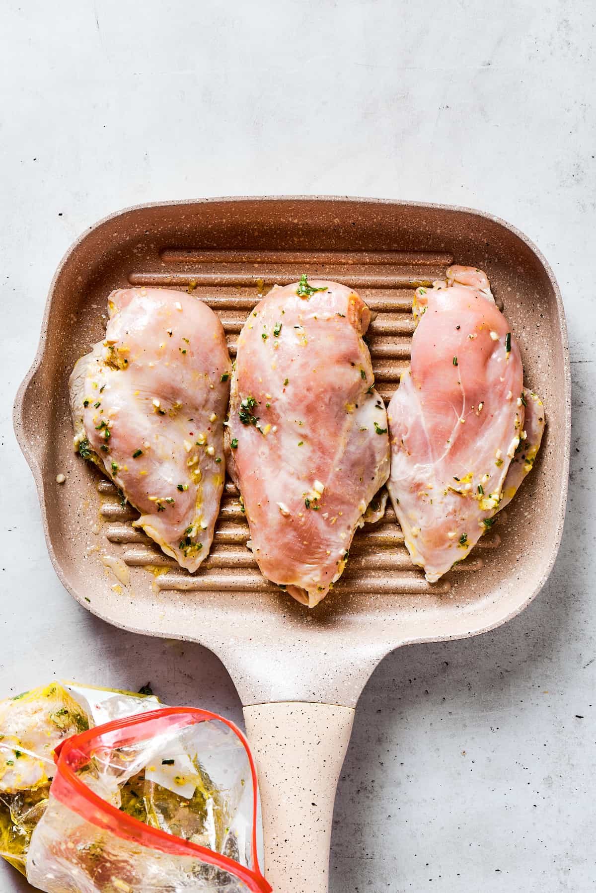 Cooking chicken on a grill pan.