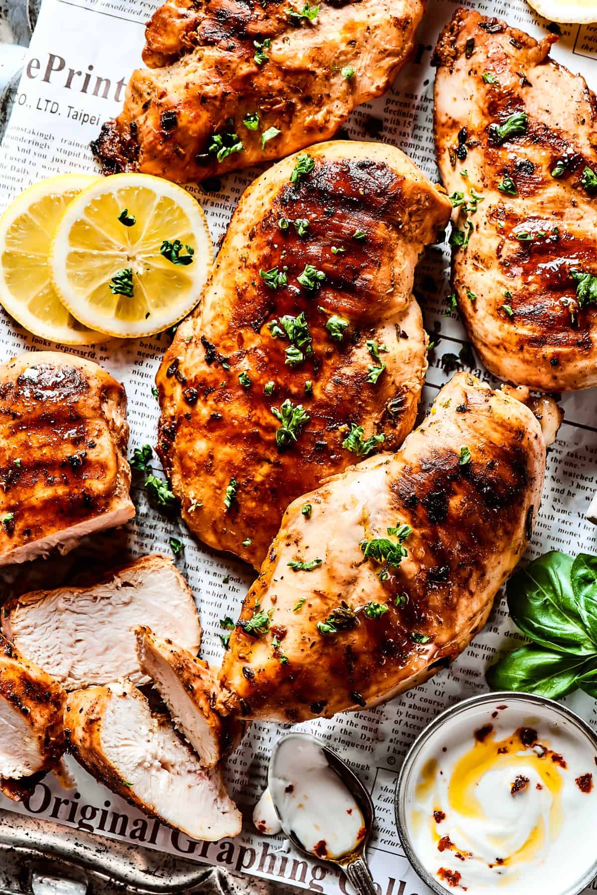 A metal tray with cooked, marinated chicken.