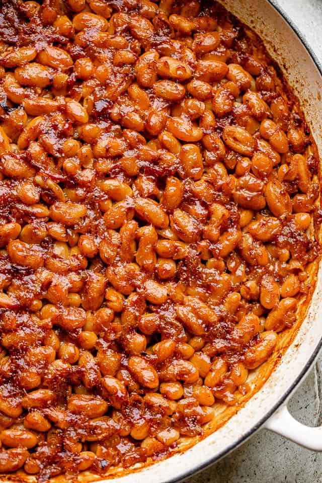 pot of baked beans topped with bacon