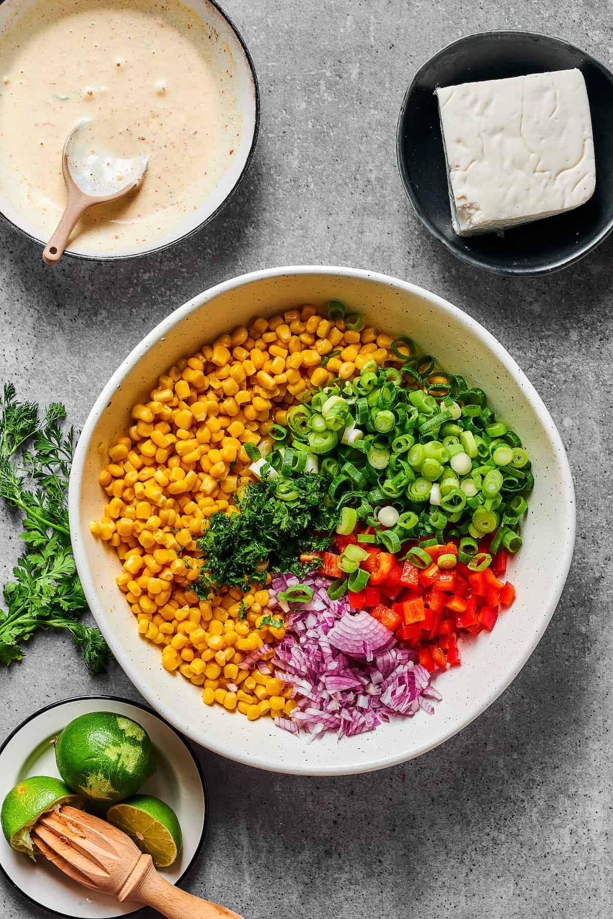Elote salad ingredients in a bowl.