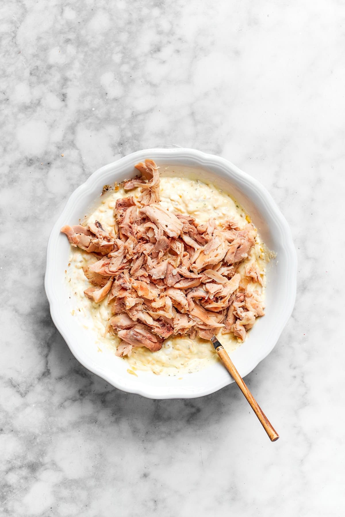 Chicken is mixed with cream.