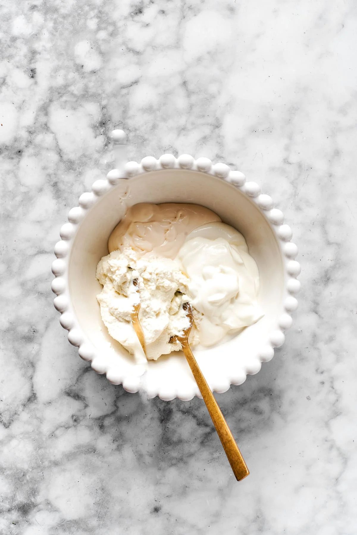 Added cheese mixture ingredients to a white bowl.
