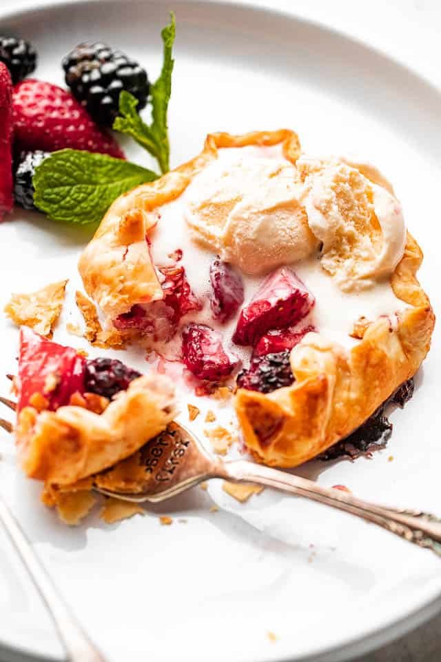 side view f berries stuffed in a mini galette and topped with ice cream