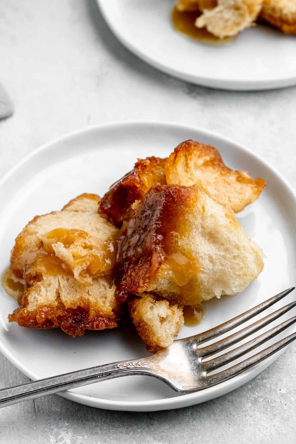 A serving of monkey bread on a dessert plate with a fork.