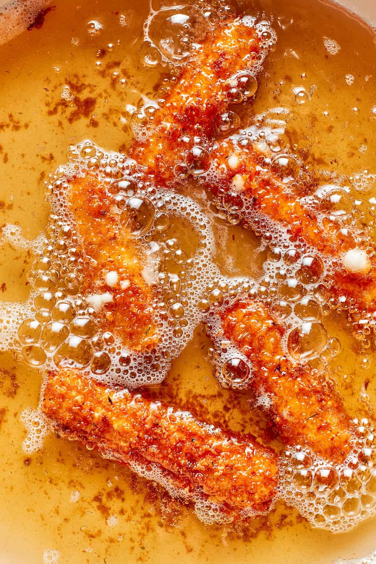 The mozzarella sticks are fried in oil.