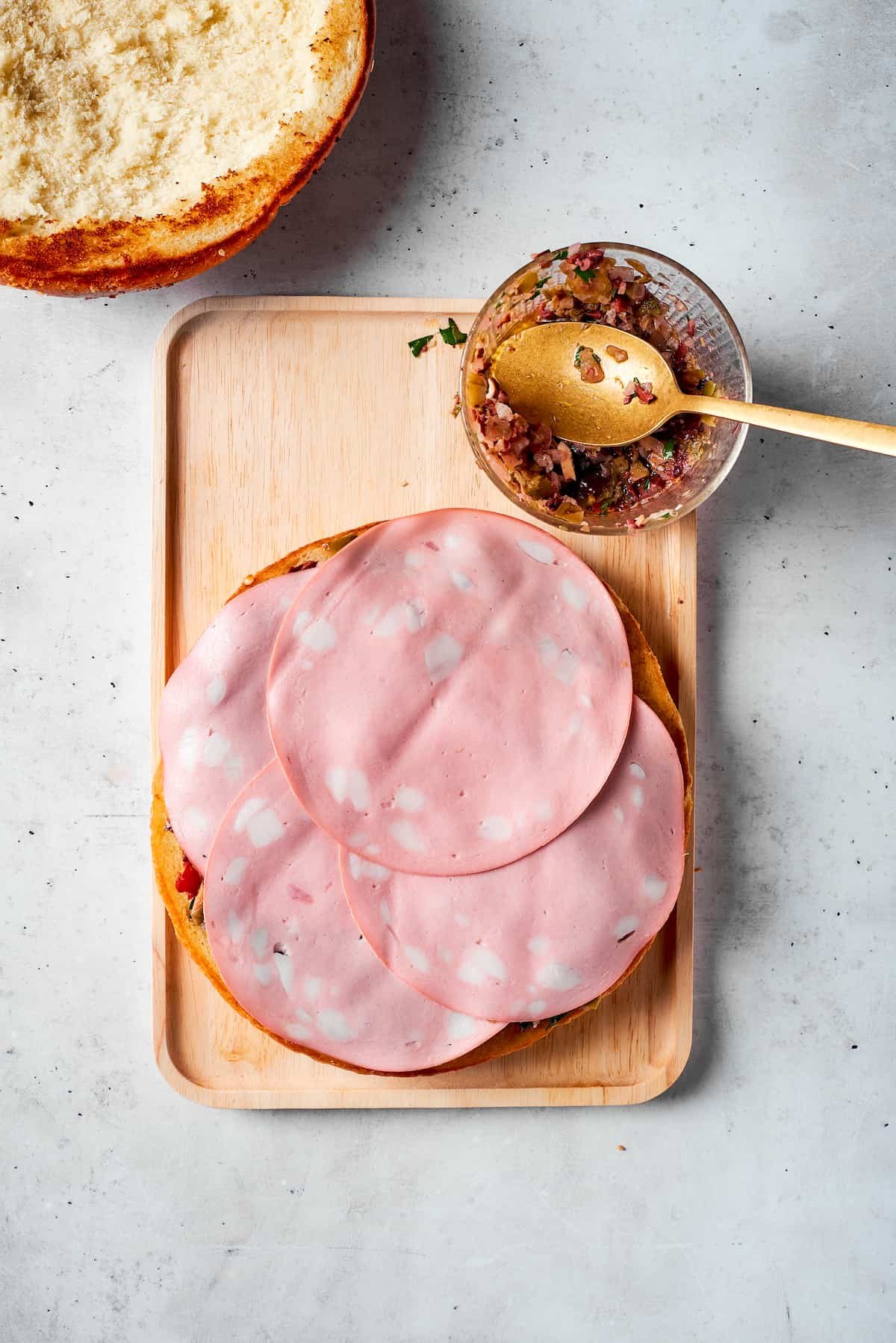 The final pieces of mortadella are added.