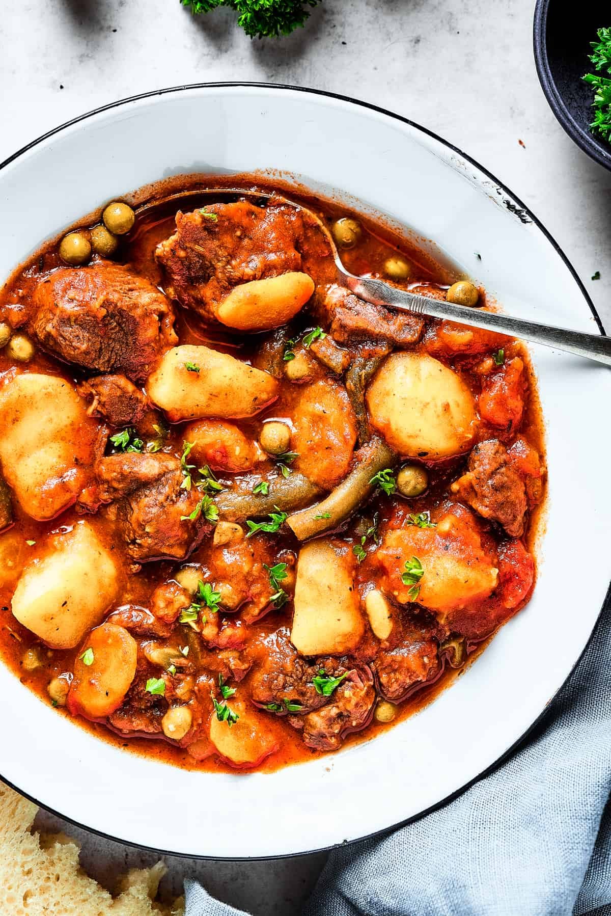 Overhead close-up shot of mulligan stew with mixed vegetables.