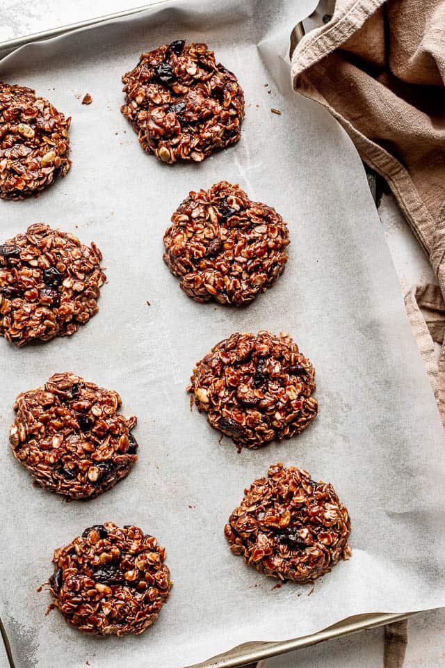 top view of oatmeal cookies set on parchment paper covered baking sheet