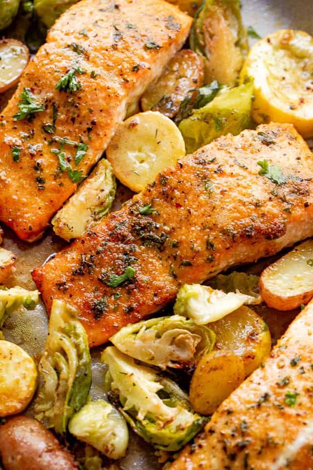 overhead shot of roasted salmon fillets with brussel sprouts and yellow squash