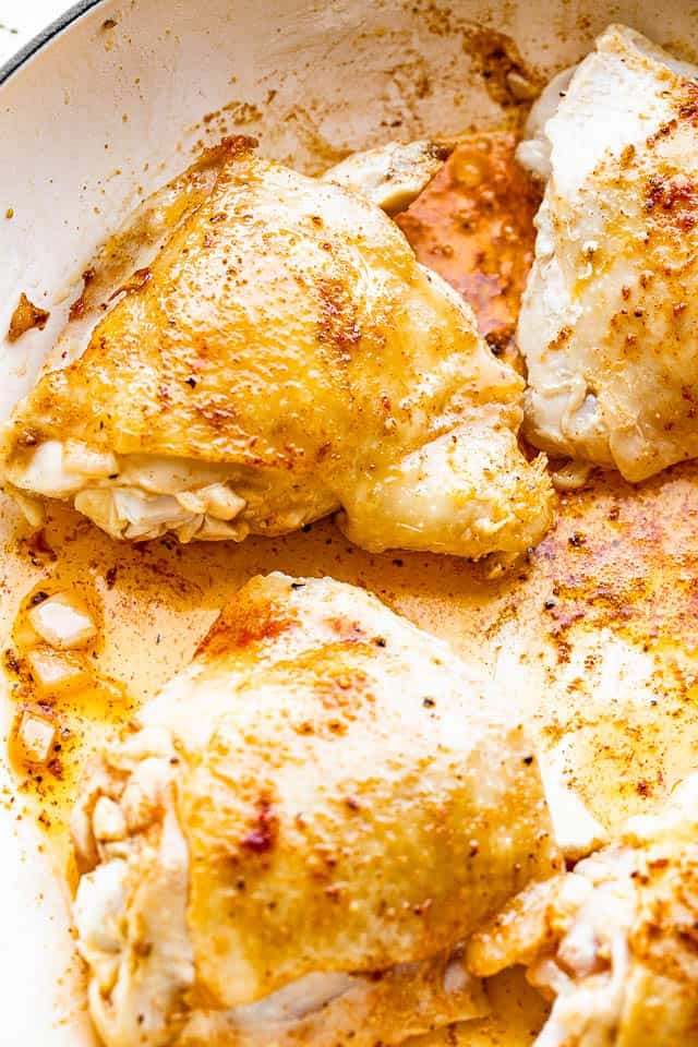 frying chicken thighs in pan
