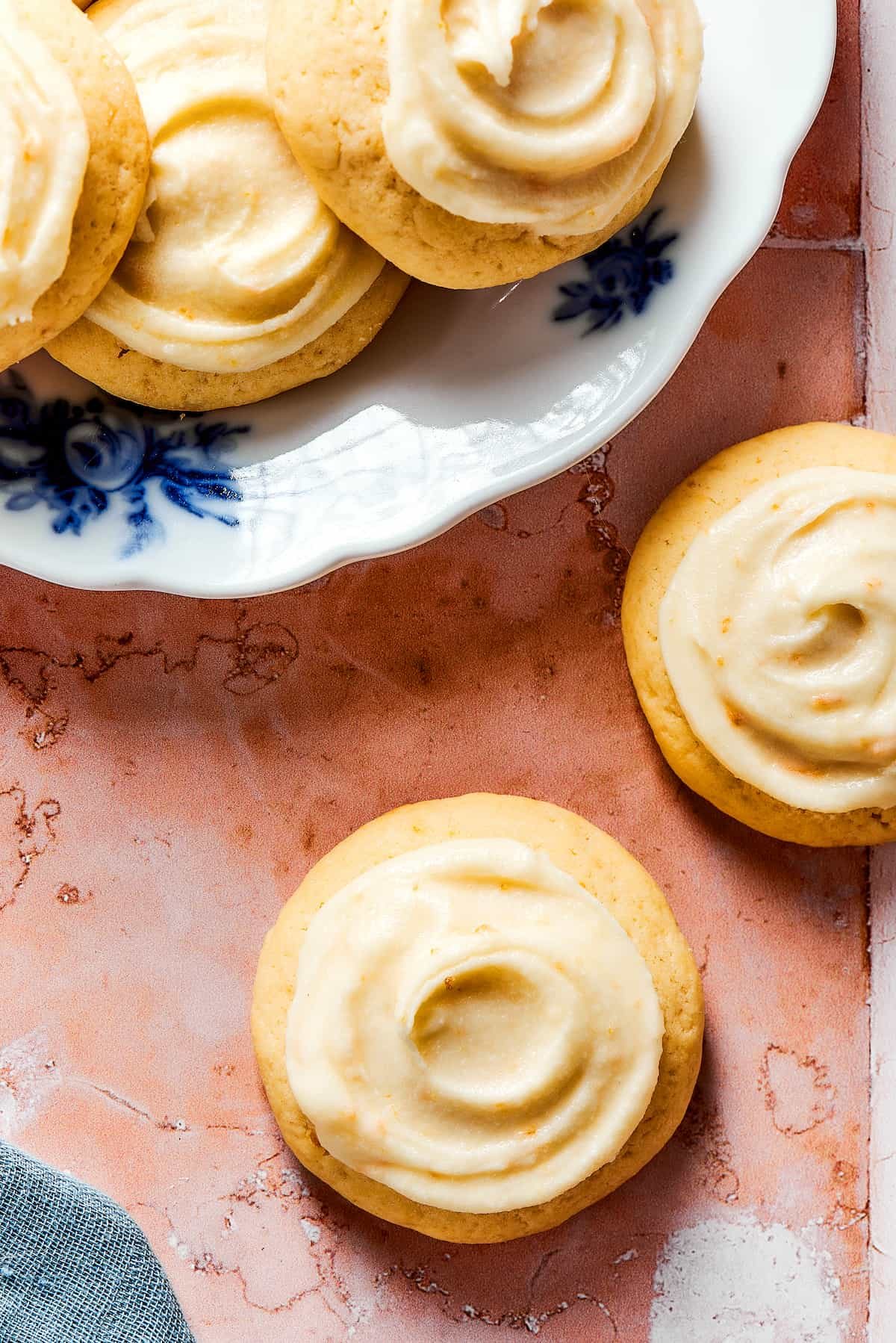 Orange cookies with homemade icing swirled on top.