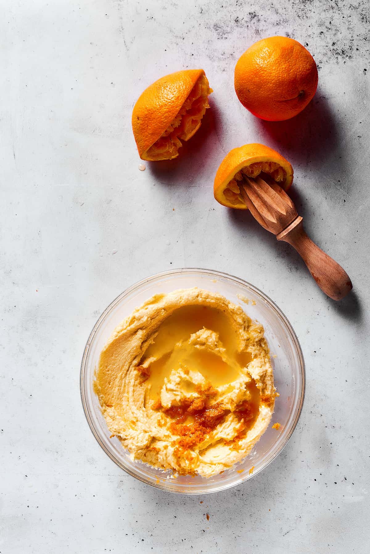 Adding orange juice to cokoie dough.