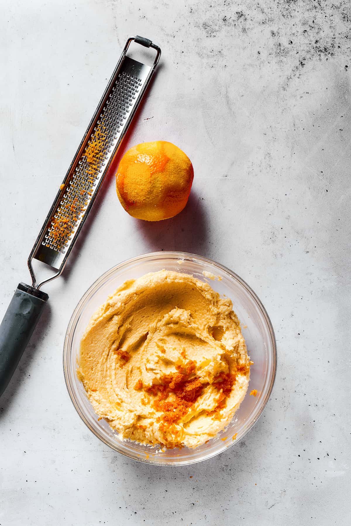 Adding orange zest to cookie dough.