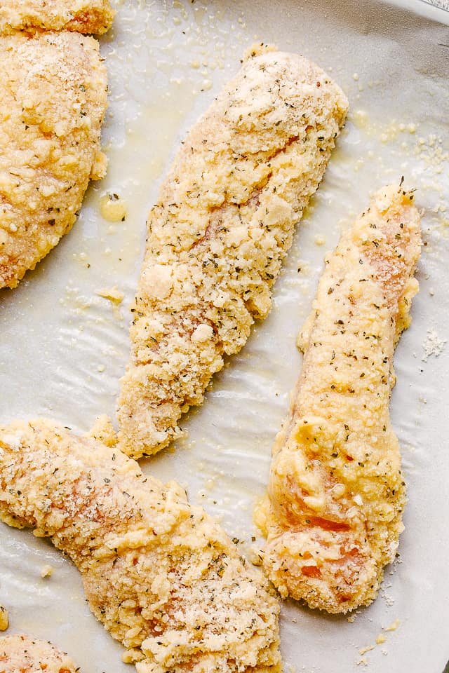 Batter coated raw chicken tenders.