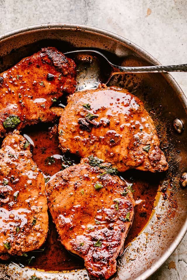 Skillet with pan fried pork chops