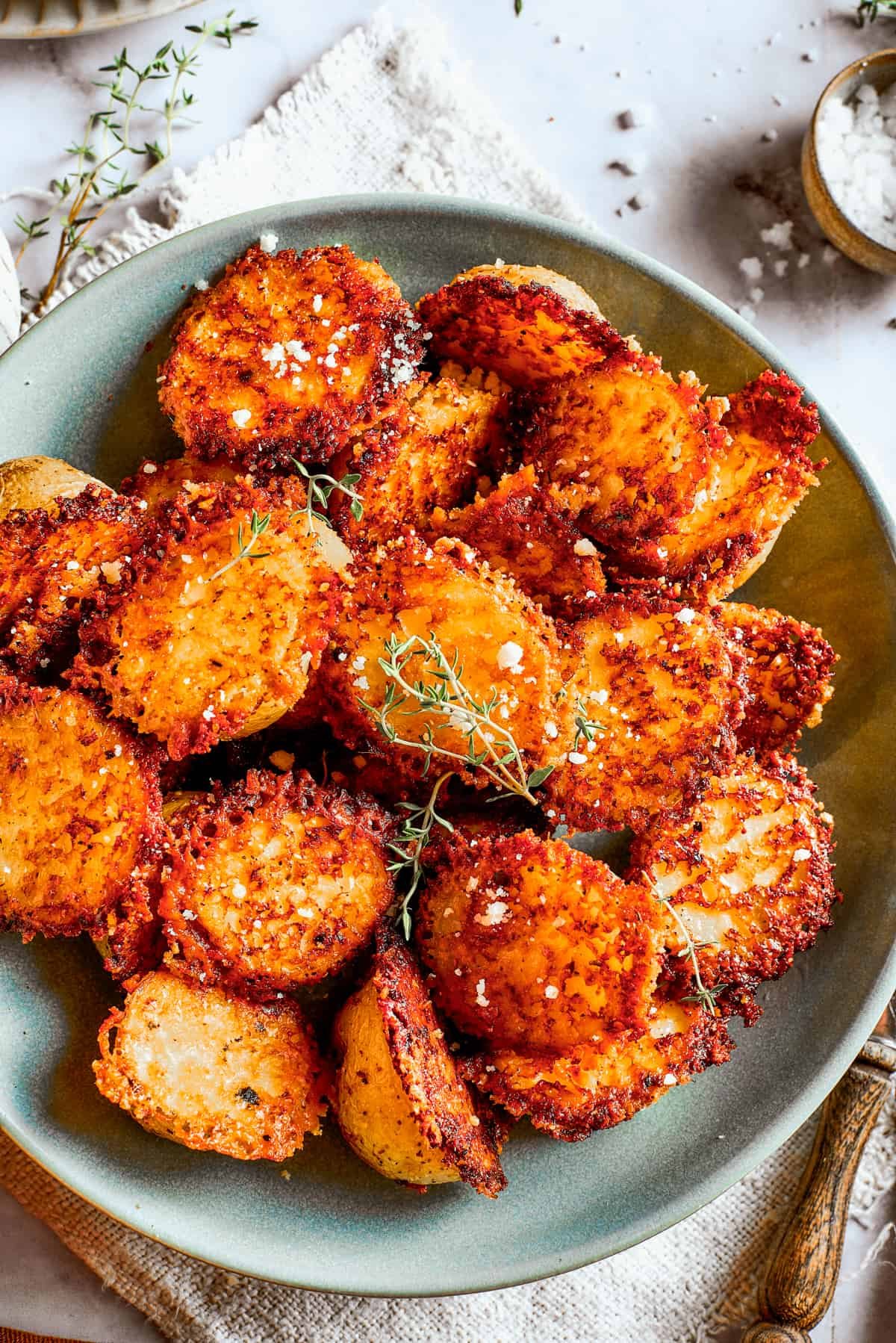 Overhead image of parmesan-crusted potatoes in a bowl.