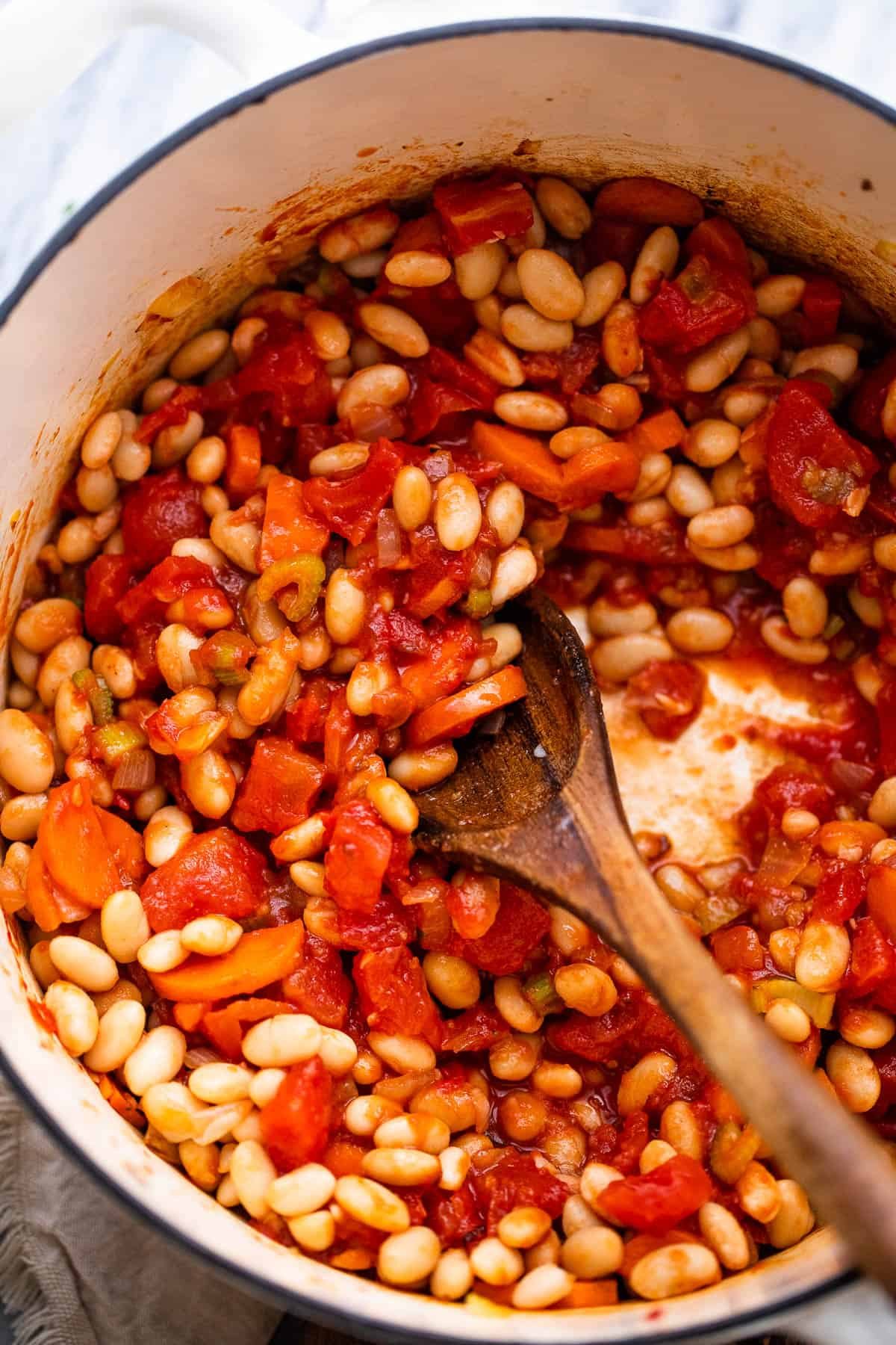 cooking beans and tomatoes in dutch oven