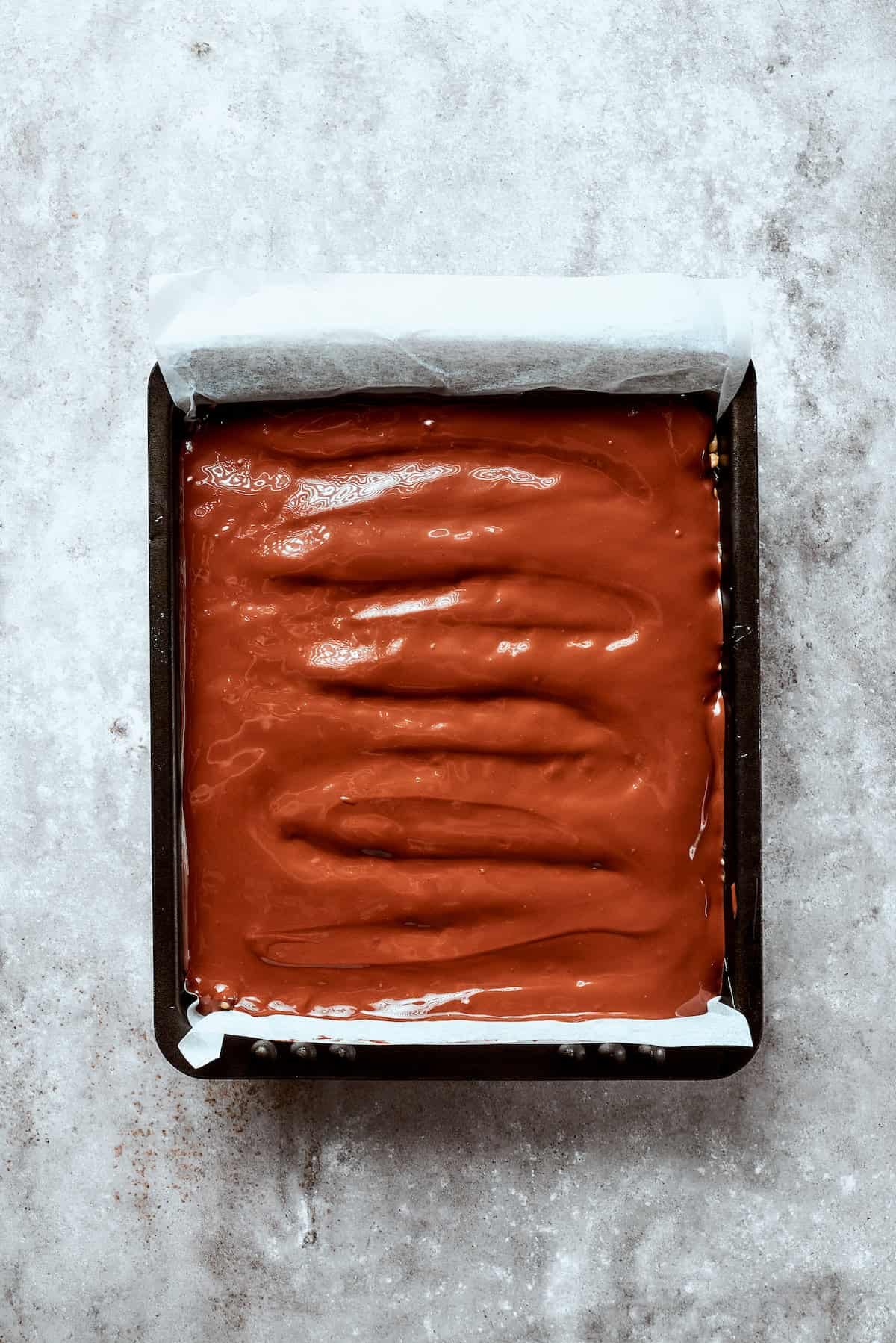 Melted chocolate tops the rice crispy base.