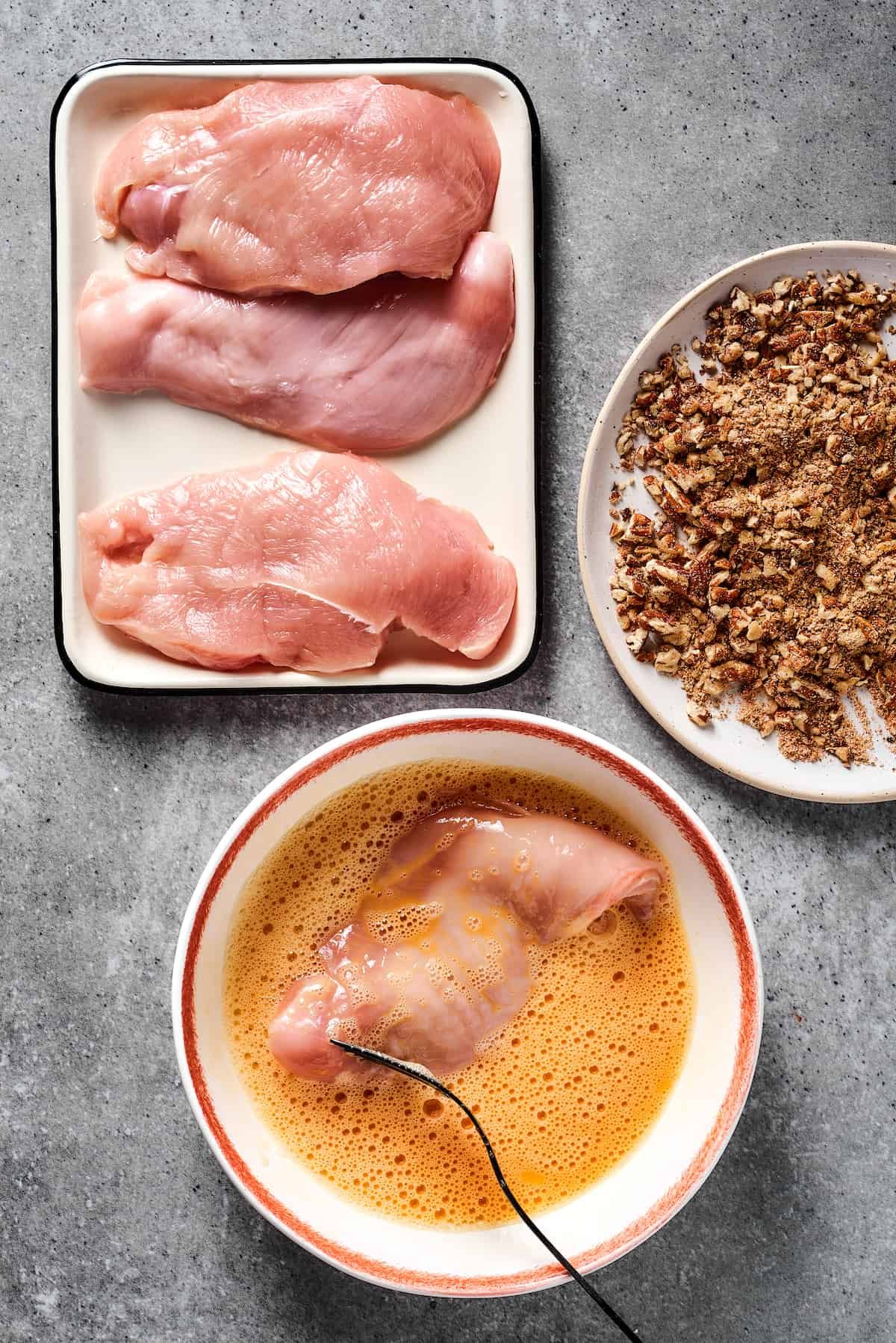 Breading chicken.