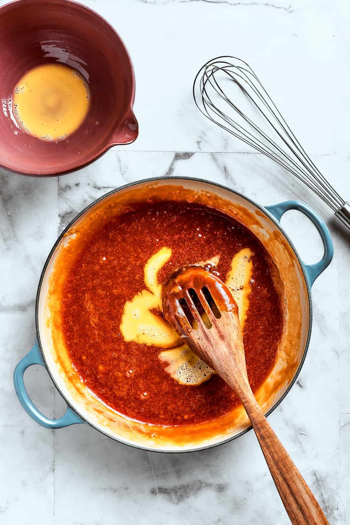 A wooden spoon mixed the eggs into the filling.