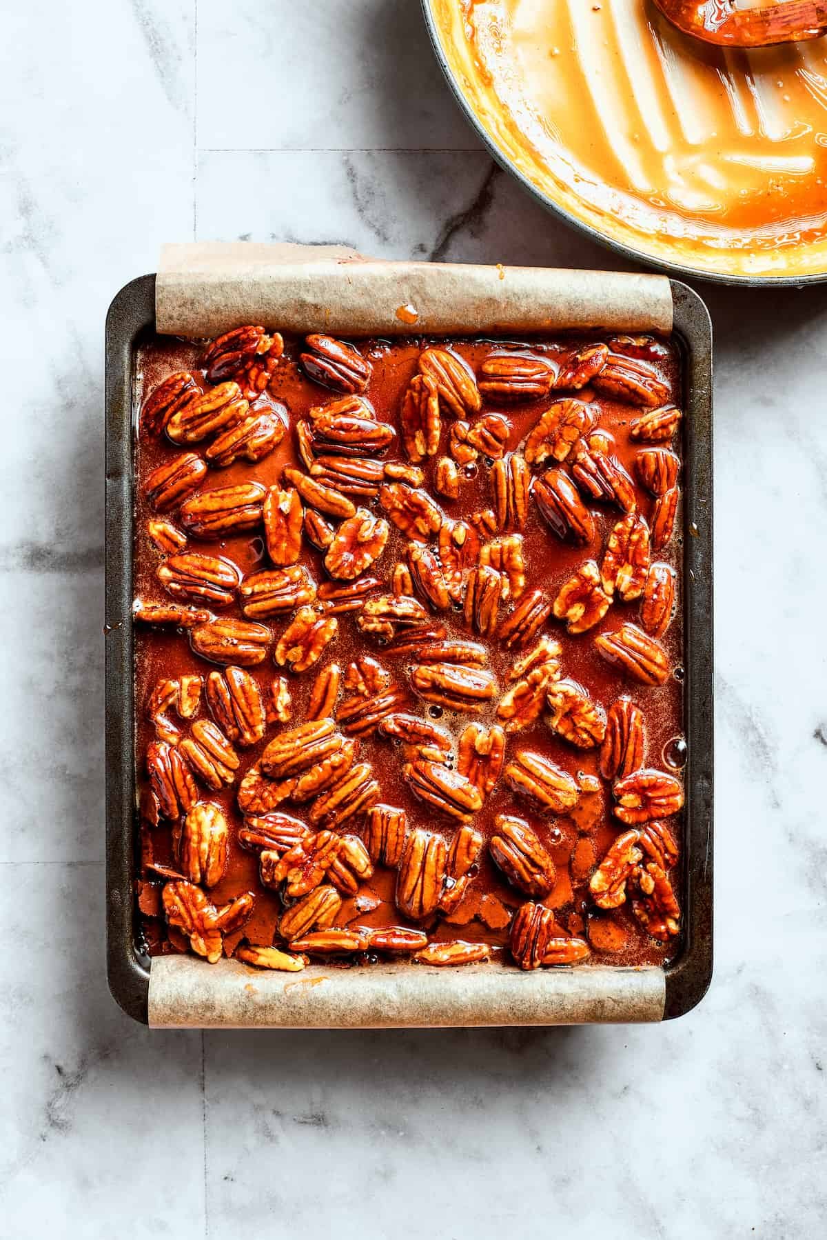 The pecan pie filling is added to the top of the brownies.