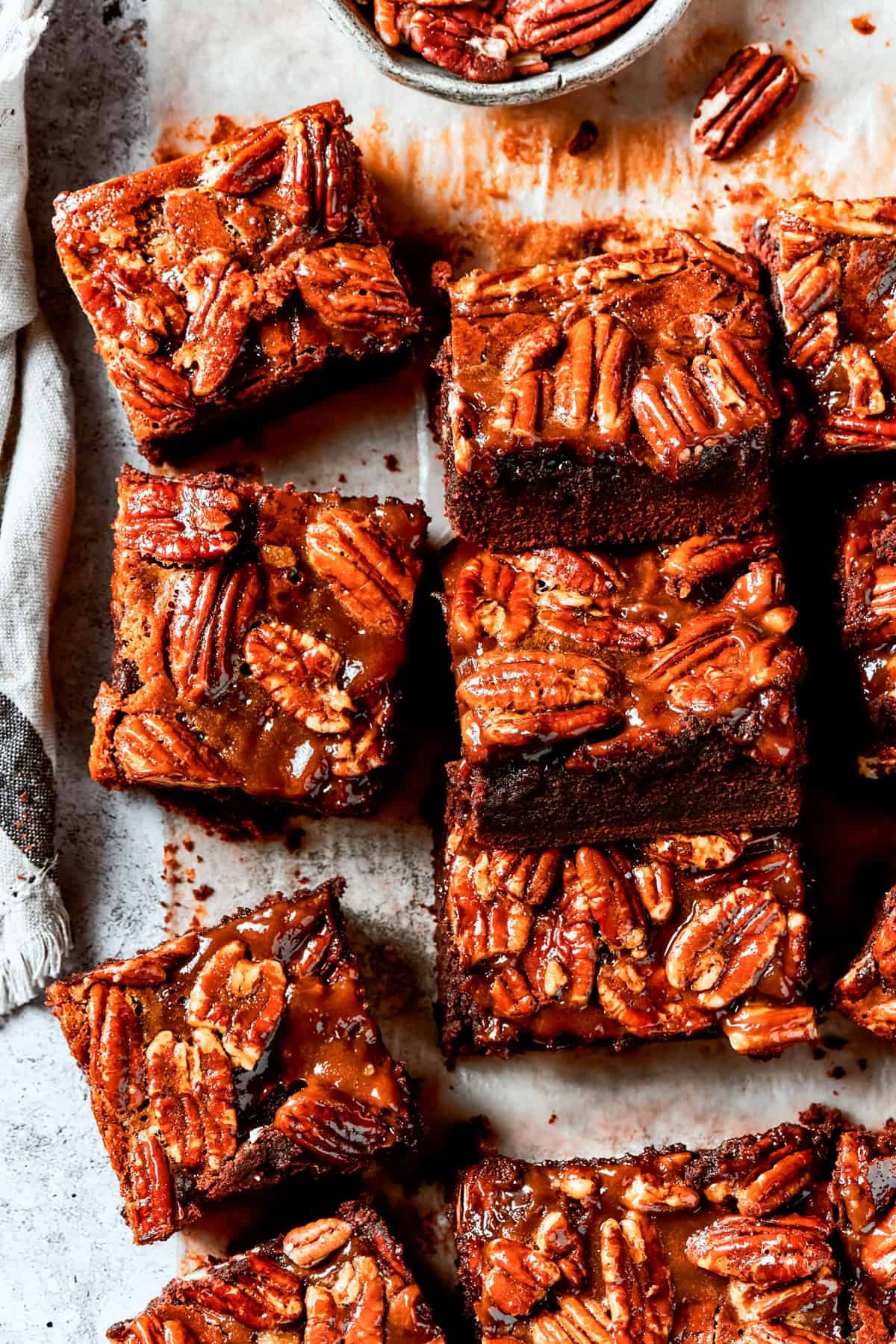 Pecan Pie Brownies lined on parchment paper.