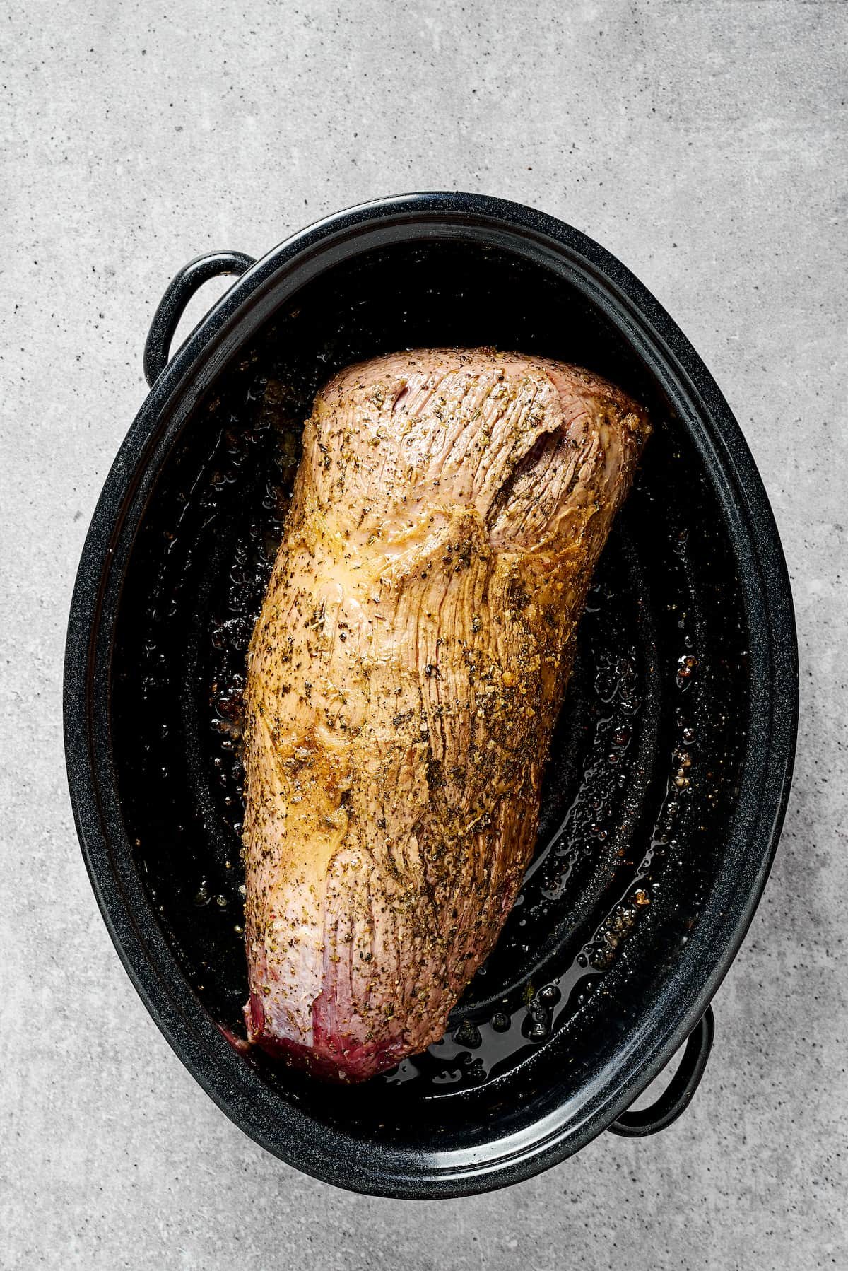 A rump roast browning in a Dutch oven.