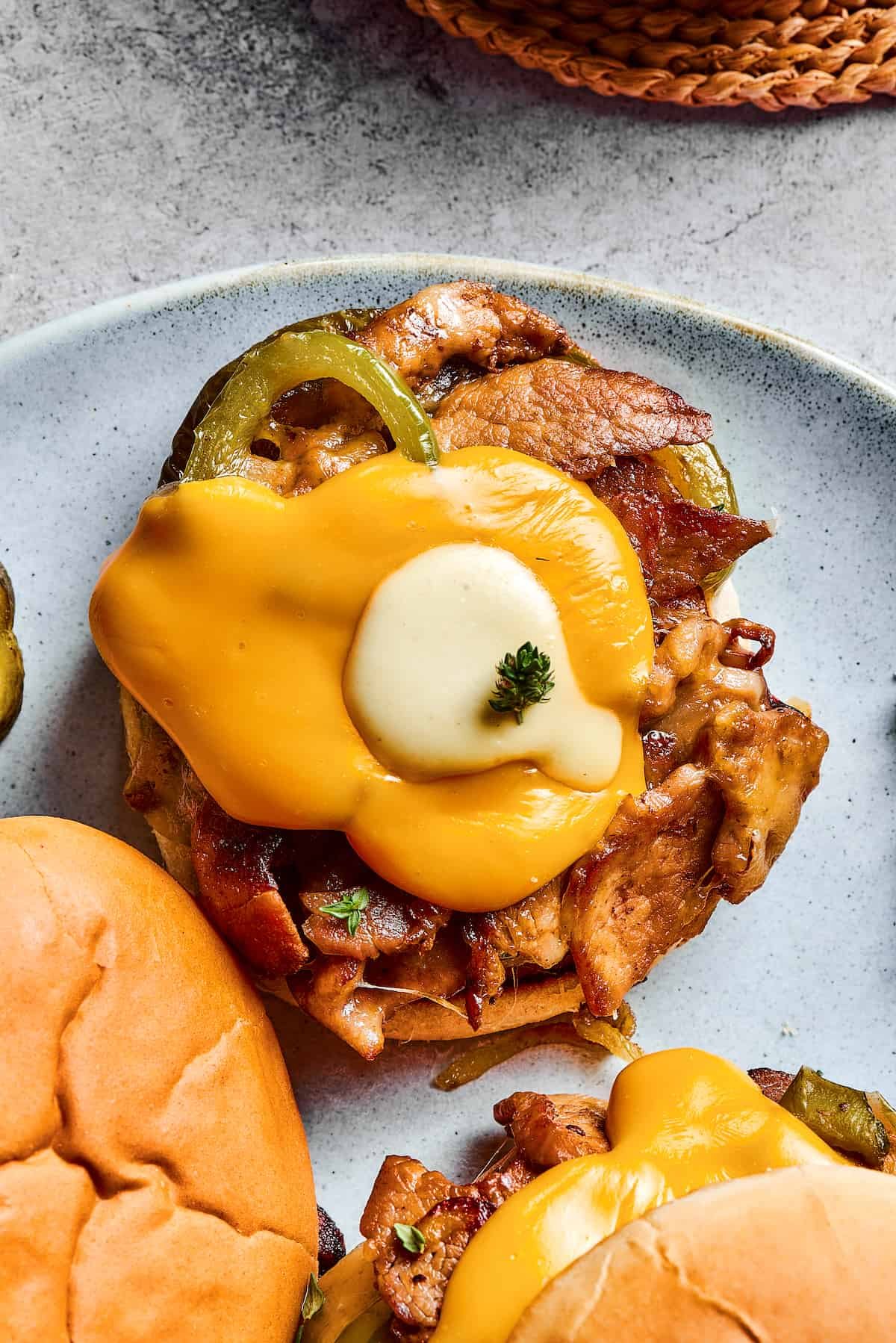 This easy Philly Cheesesteak Burger is a satisfying, cheesy, hot sandwich made with thinly sliced steak, peppers, onions and Provolone - yum!
