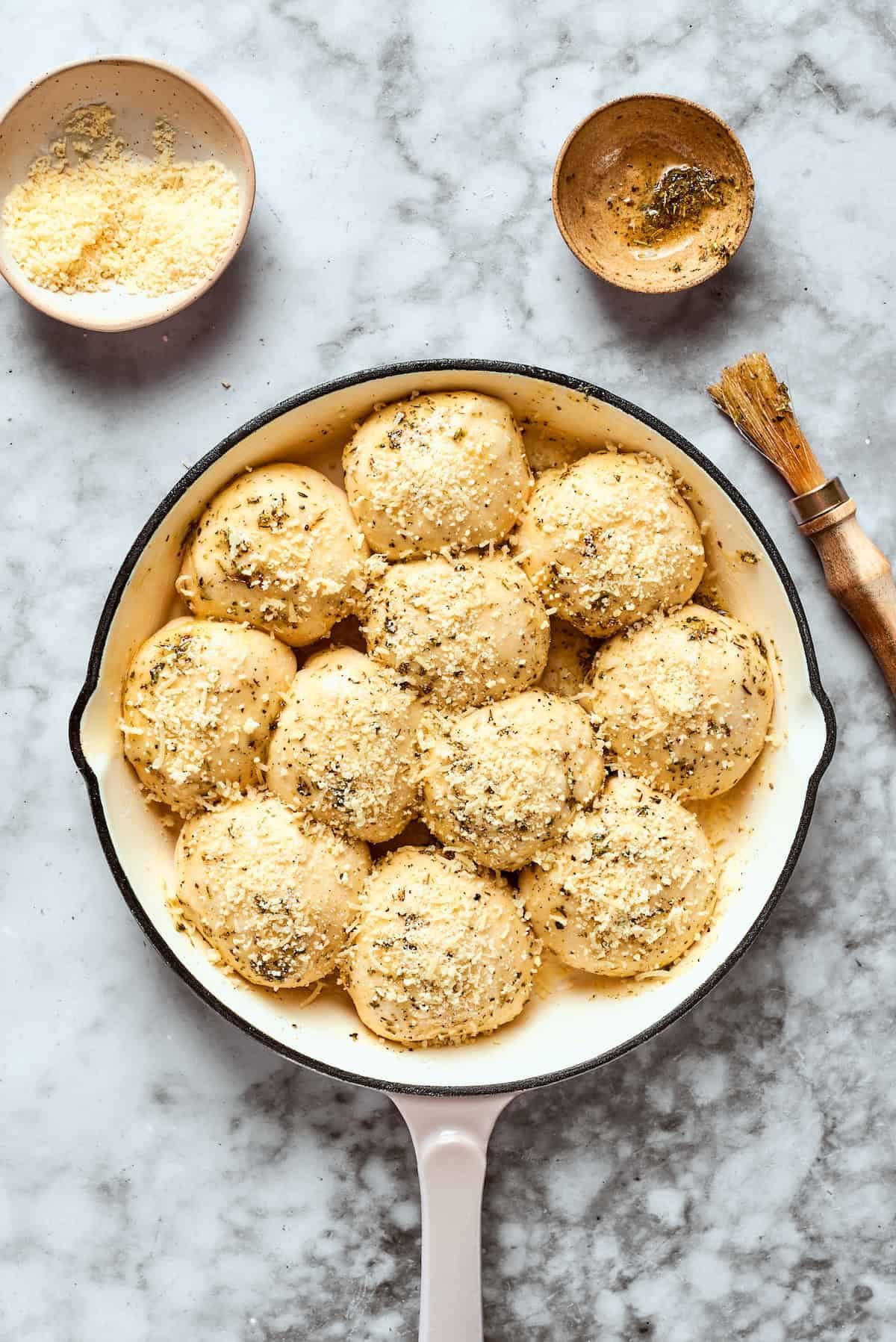 Pizza bites are ready to be baked in a skillet.