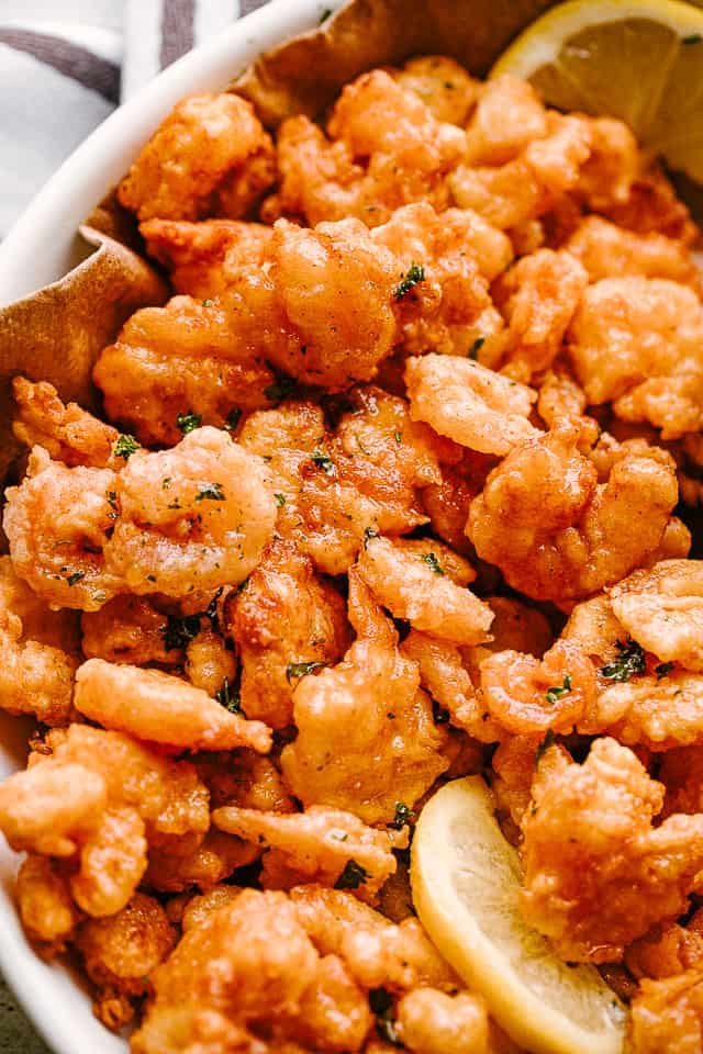 Popcorn shrimp on a plate with lemon