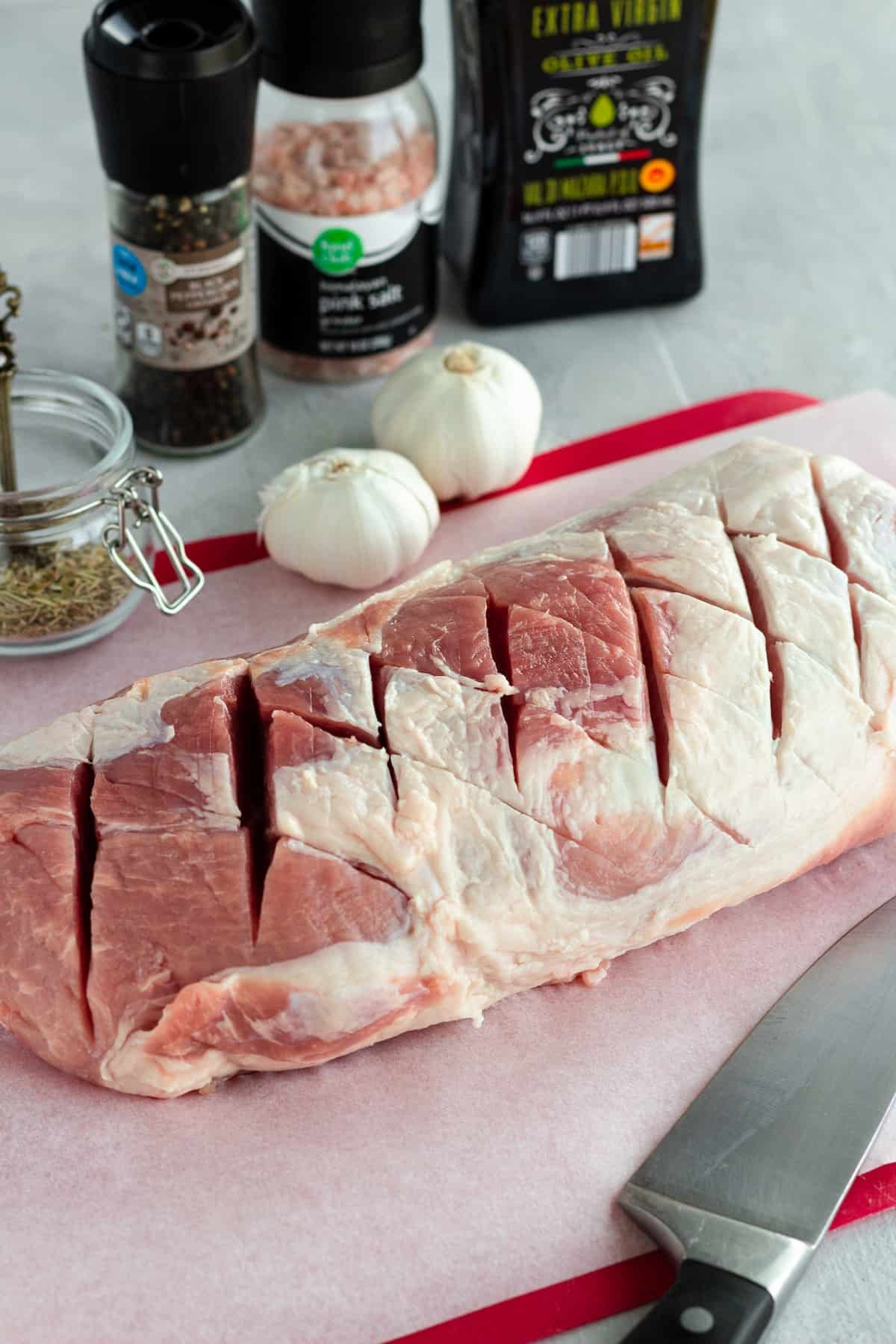The Criss-Cross Slicing Method Exhibited on a Roast Over a Red Cutting Board