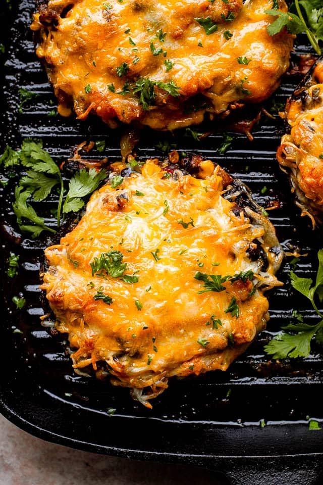 melted cheese over portobella mushrooms on the grill