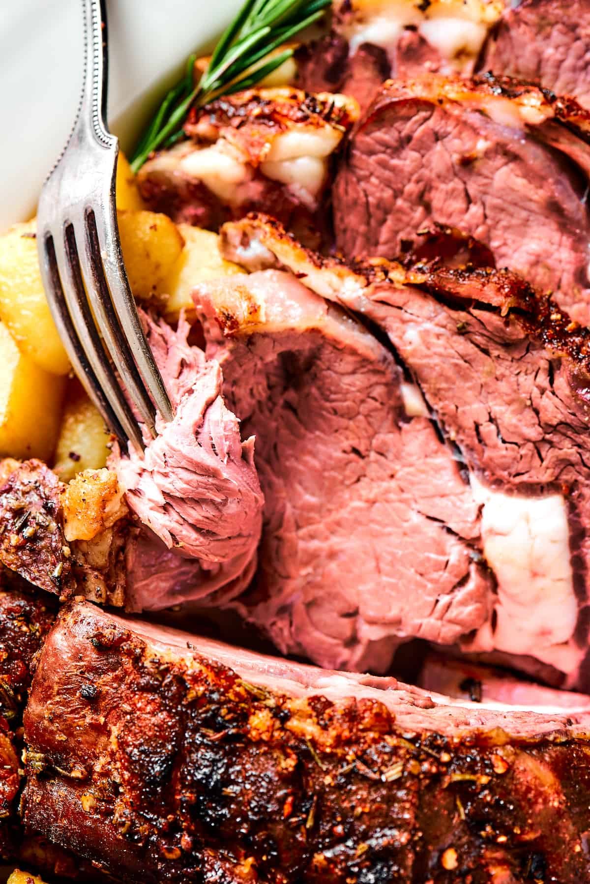 A fork serving a slice of rib roast.