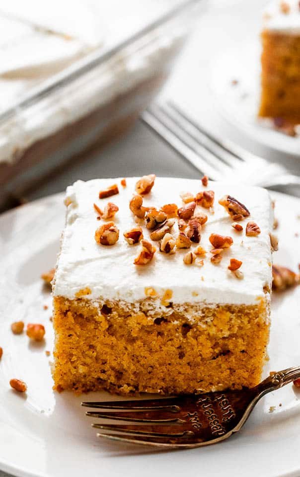 pumpkin bar slice topped with cream cheese frosting a chopped pecans