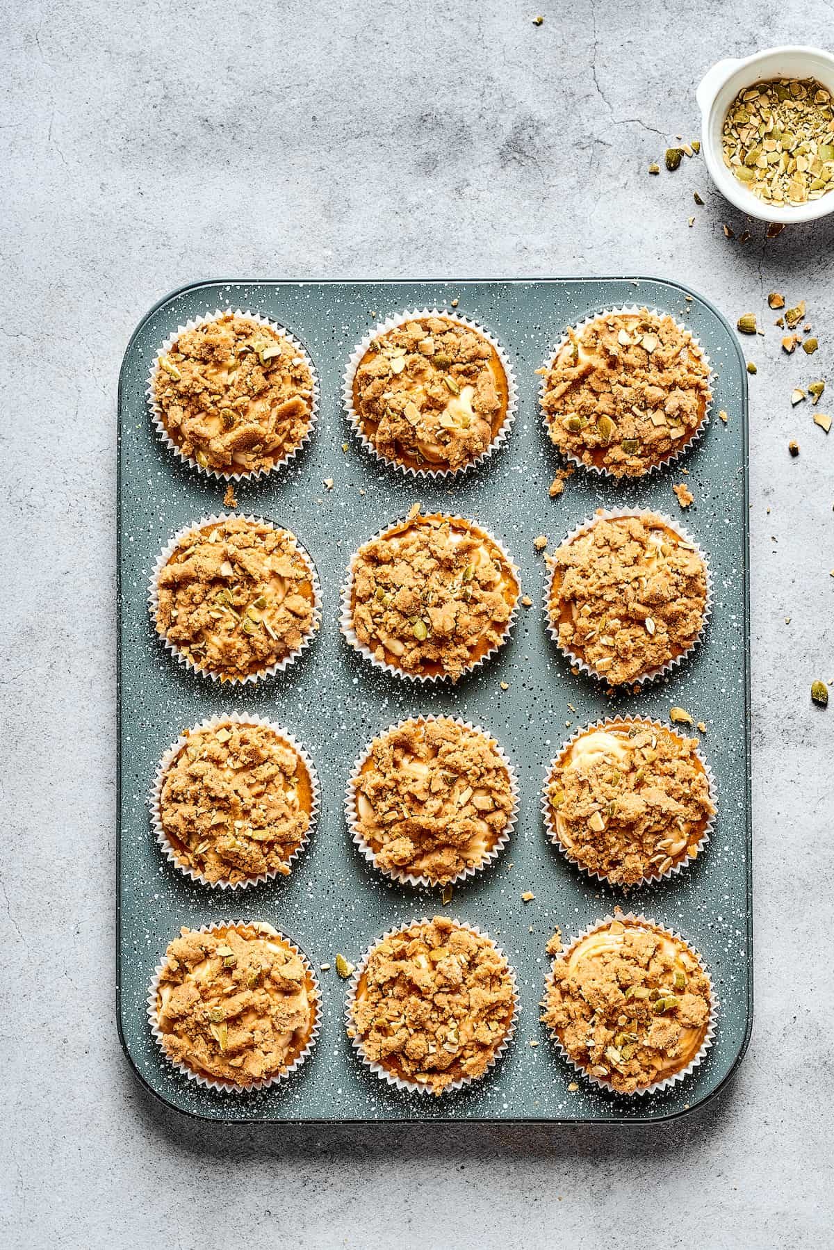 Pumpkin cream cheese muffins in a tin.