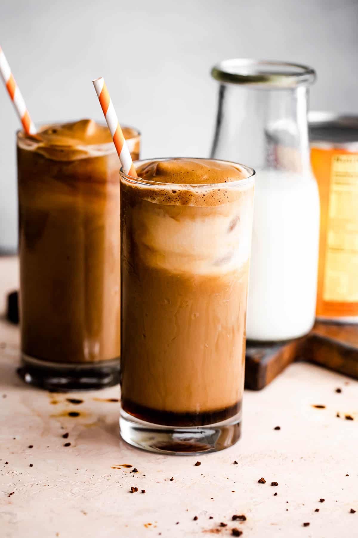 Pumpkin Cream Cold Brew served in two drinking glasses with a milk bottle placed right beside them.
